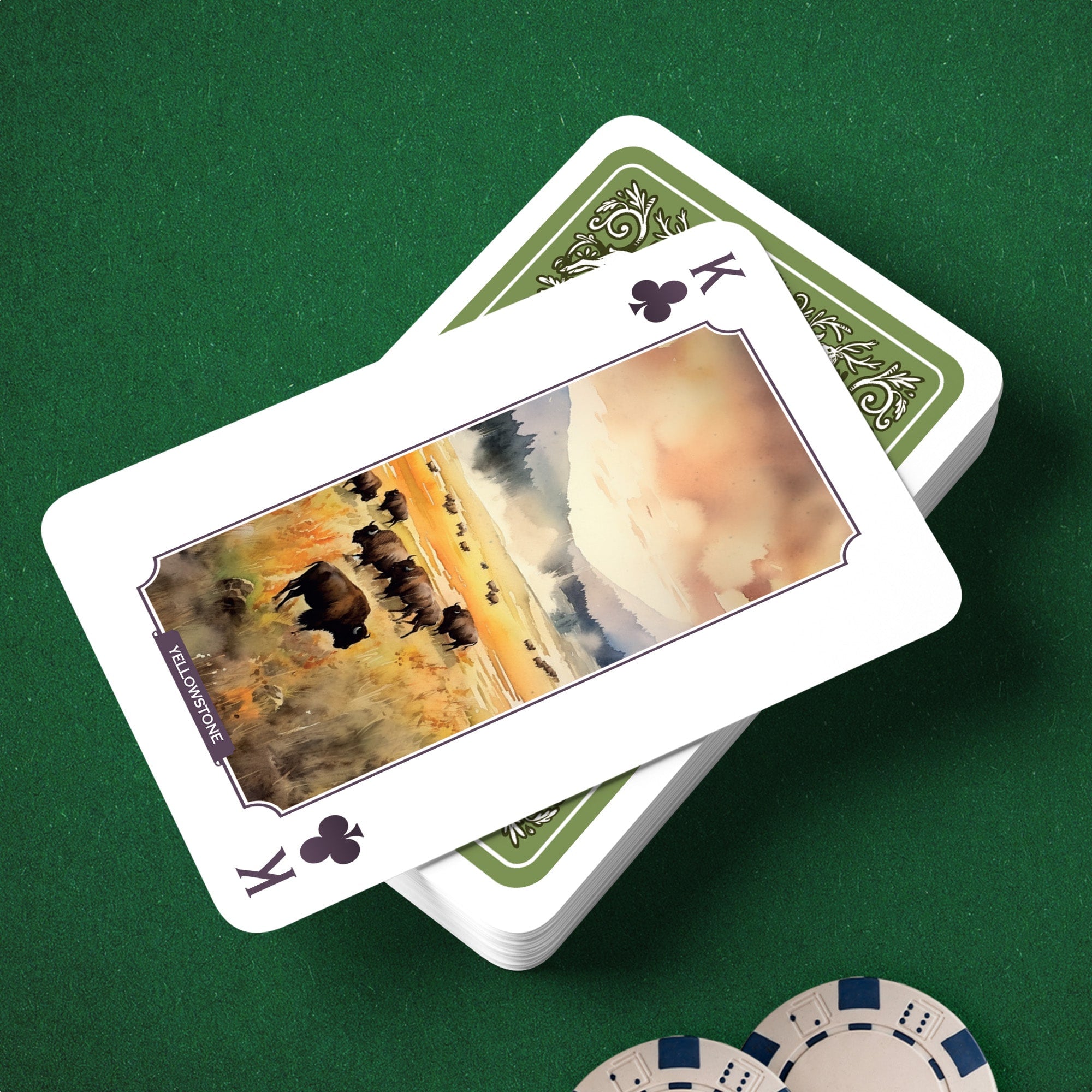 Person holding game cards with a board game in the background on a wooden table.